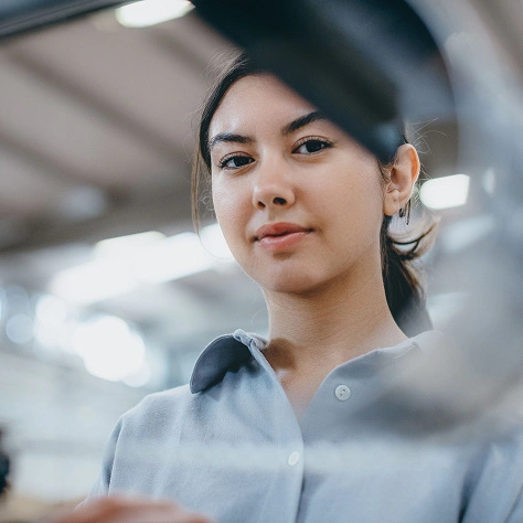Mitarbeiterin im Kundendienst bei ZAG, freundlich am Arbeitsplatz in einem modernen Büro.